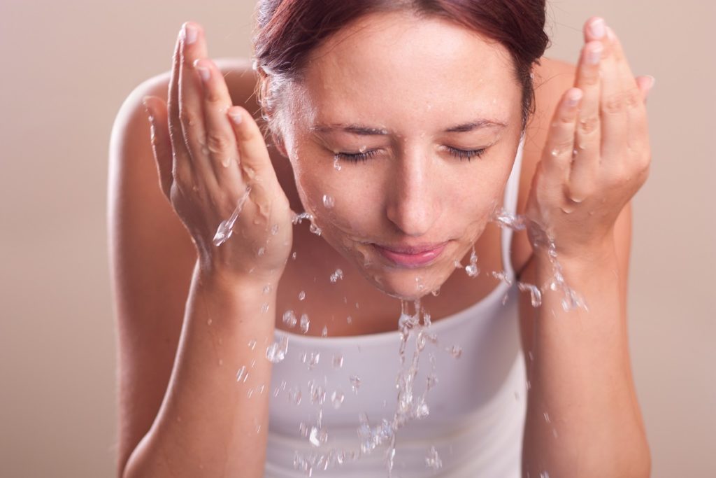 girl washing her face 